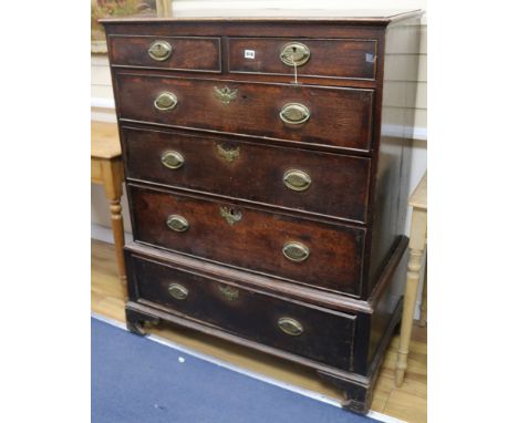A George III oak chest on stand fitted two short drawers and four graduated long drawers, on bracket feet W.106cm