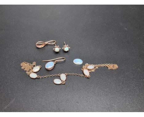 A yellow metal necklace set six opals; together with a pair of yellow metal earrings, set single cabochon opal; and a pair of