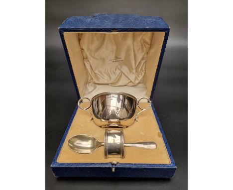 A cased silver Christening set, comprising bowl, fork and napkin ring, by Walker &amp; Hall Ltd, Sheffield 1937, 190g. 