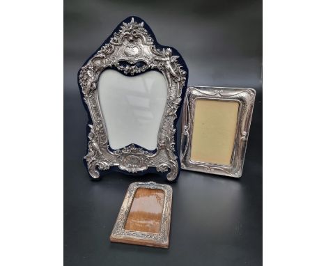 An ornate silver mounted easel photograph frame, by&nbsp;Neil Lasher Silverware Ltd, London 1992, 32cm high; together with tw