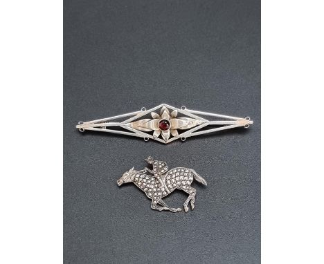A vintage marcasite jockey and horse brooch, stamped 'silver', 4cm; together with a silver brooch, set central garnet, by A &