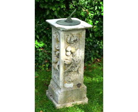 AN ANTIQUE CARVED PORTLAND STONE SUNDIAL BASE of square section, the sides carved with fruit and flower motif with top plate 