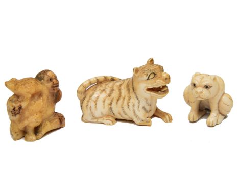 A JAPANESE NETSUKE in the form of an old man with a toad, 3.36cm high, another in the form of a seated cat, signed on the bas