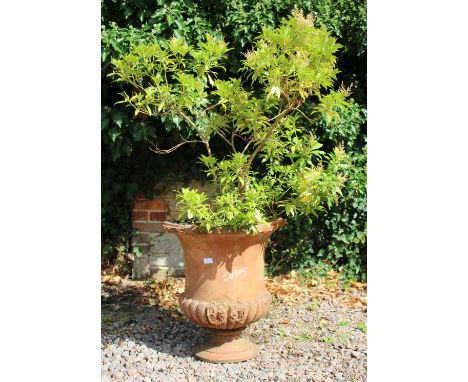 A TERRACOTTA GARDEN URN of campagna form, 63cm high, another terracotta urn shaped planter and one other, moulded on sections