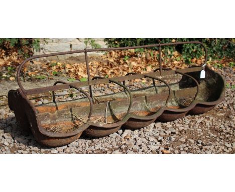 AN ANTIQUE CAST IRON TEN SECTION PIGLET FEEDING TROUGH, 126cm wide