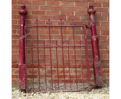 A RED PAINTED VICTORIAN WROUGHT IRON GARDEN GATE, the cast iron posts with turned finials to either side, the gate 92.5cm wid