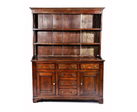 A 19TH CENTURY OAK DRESSER with two shelf plate rack above, the base with three short drawers above three further central dra