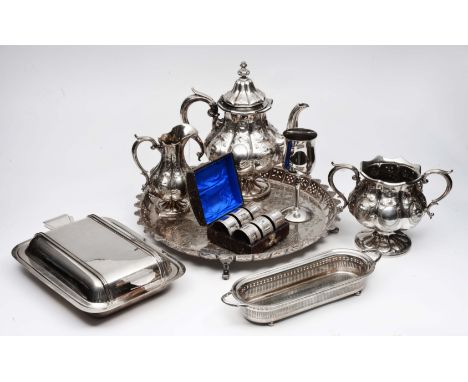 A COLLECTION OF SILVER PLATE to include a three piece tea service, a set of napkin rings in case, a circular tray, an entree 