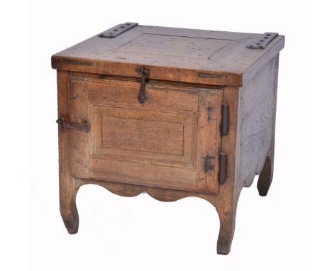 AN ANTIQUE FRENCH OAK COMMODE with hinged rising lid, panel door and iron hinges, 40cm square