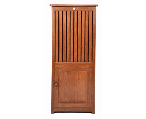 AN INDIAN TEAK DHOBI OR LAUNDRY BASKET, the upper section with lifting lid and lath sides over a single cupboard door beneath