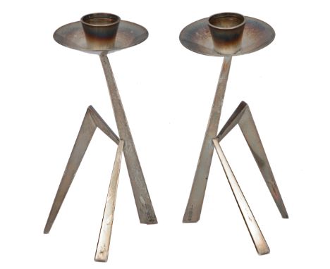 A PAIR OF SILVER MANTIS CANDLESTICKS with circular drip pan and standing on geometric tripod base, with marks for London and 