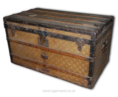 A well-travelled Louis Vuitton Travel Trunk having wooden protective rubbing strips, metal corners, banding and carrying hand