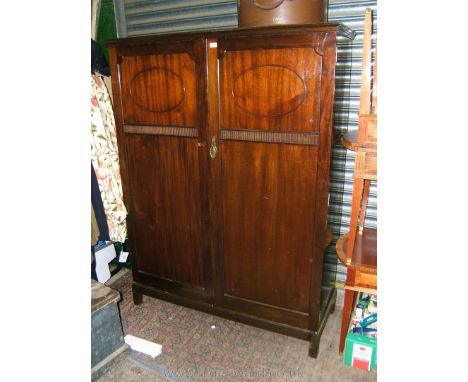 A good 1940's Mahogany Gent's fitted two door Wardrobe havimg moulded cornice over pair of opposing two panel doors, full len