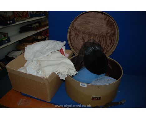 A box of Linen with a hat box and vintage hats