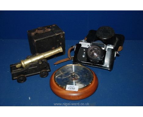 A Zenit-E Camera, box Camera, Barometer, pair of elephant Bookends and a heavy cast metal and brass model of a Canon