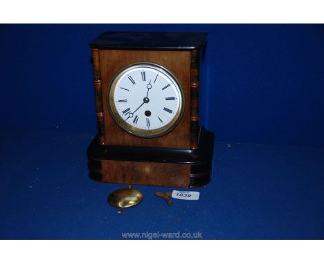 An Elegant late 19th century Walnut and ebonised Mantle Clock with stylised bamboo column detail, Roman numerals on plinth ba