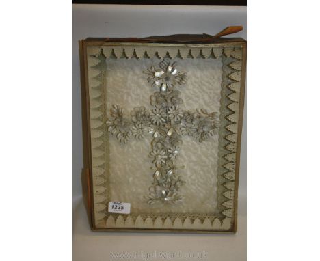 An unusual 19th century shell work crucifix finely worked in flowers composed of tiny clam shells and mother of pearl framed 