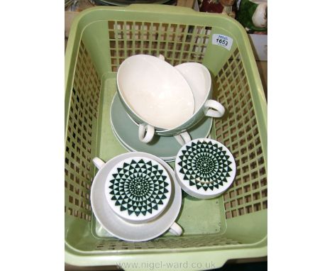 A quantity of Poole pottery Kitchenware including soup dishes and saucers, and two spice jars