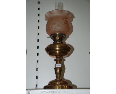 A Hinks Brass oil Lamp with pink glass shade.