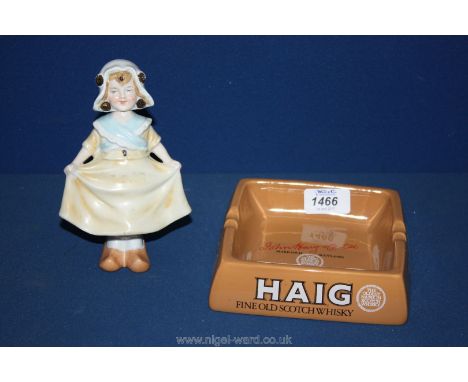 An Edwardian 'Nodding' Doll in Dutch style and a Carltonware 'Haig' Ashtray