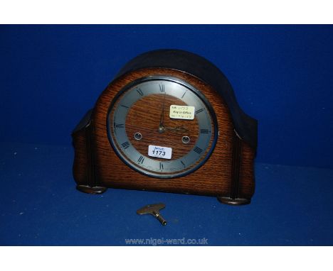 A wooden Smith's mantle clock with key and pendulum