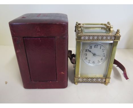 A carriage clock with travel case, Arabic dial and floral boarders to panel, some signs of wear to case, with key, not curren