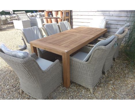 A Bramblecrest Batu vintage teak table with eight Oakridge high back armchairs 