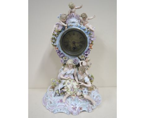 Porcelain figural mantle clock with a Buren movement, 38cm tall, running, some losses to case 