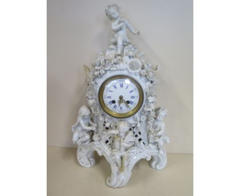 A Blanc De Chine floral encrusted mantle clock with Putti as the four seasons, with restorations and losses - 48cm tall 