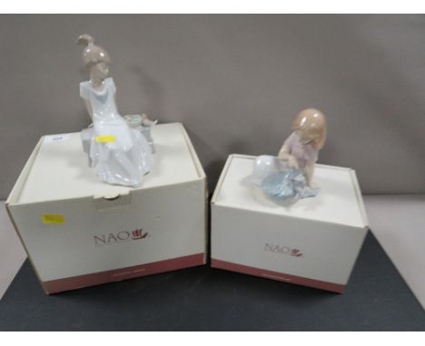 Two boxed Nao figurines of seated girls 