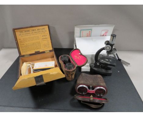 A vintage first aid box, microscope and 2 pairs of opera glasses