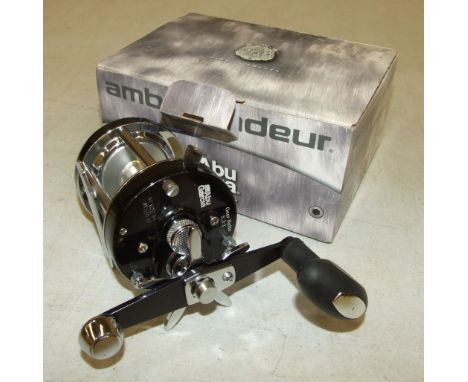 An Abu Garcia Ambassadeur multiplying reel in leather case, with oil bottle and spanner. 