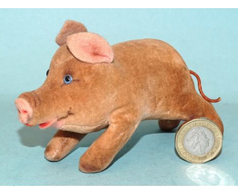 Steiff, a small brown velveteen piglet with blue glass eyes and pink felt ears, nose and mouth, 10cm long. 
