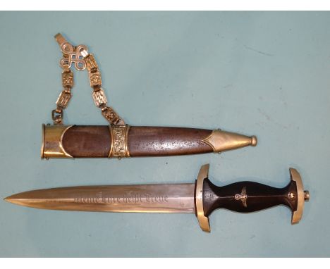 A WWII German SS Nazi dagger with ebonised grip with metal eagle, swastika and SS device, the cross guard stamped "I", the bl