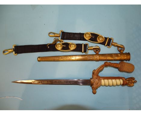 A WWII German Kriegsmarine naval officer's dress dagger by Carl Eickhorn, with gilded pommel and cross guard with press stud 