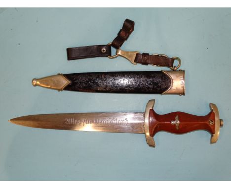 A WWII German Third Reich NSKK dagger, the brown wooden grip with eagle, swastika and enamelled circular SA device, the cross
