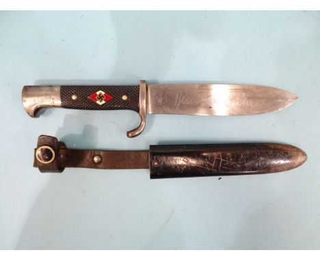 A WWII Third Reich Nazi German Hitler Youth dagger with hooked pommel, black chequered grip inlaid with an enamel Hitler Yout