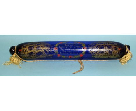 A Bristol glass rolling pin enamelled with two ships and verse, 38cm long. 