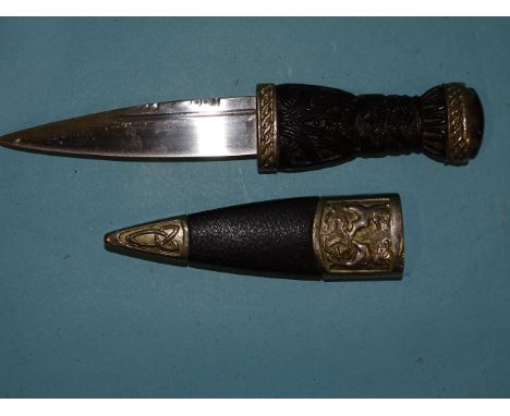 A 20th century Scottish dagger (sgian dubh), the carved wood grip with metal mount, stone pommel and metal-mounted scabbard, 