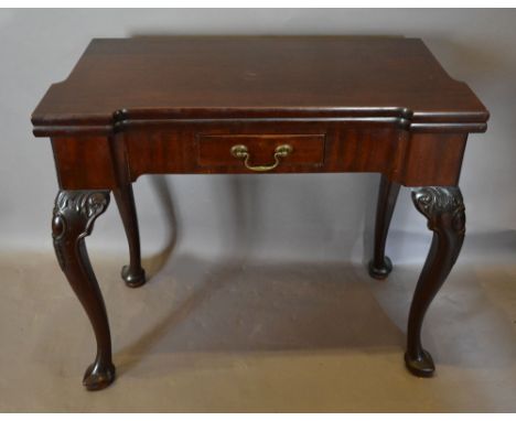 A 19th Century Mahogany Card Table, the hinged top enclosing a baize lined interior above a frieze drawer with brass swan nec