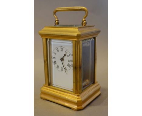 A Miniature Brass Cased Carriage Clock, the enamel dial with Roman numerals with lever escapement and carrying handle, 7 cms 