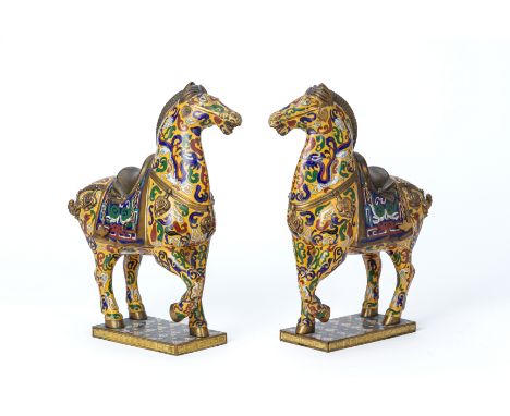 A PAIR OF CLOISONNE ENAMEL MODELS OF HORSES Decorated with a yellow ground, dragons amongst clouds and brass mounts, 34cm hig