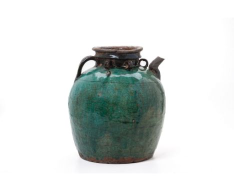 A GREEN GLAZED SHIWAN CERAMIC PITCHER
With a crackled glaze and four lugs, single handle and spout
30cm tall
Condition: For a
