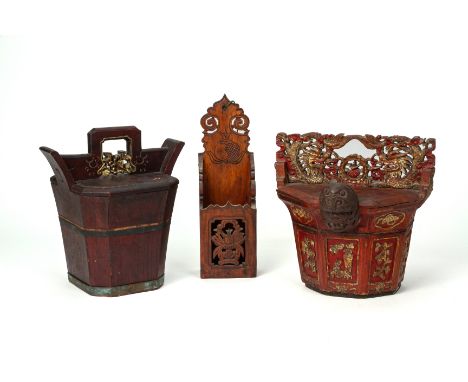 TWO CARVED WOODEN BASKETS AND A WALL BRACKET
Comprising two water baskets, the largest decorated with giltwood carved dragons