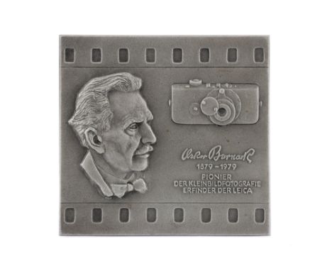 An Oskar Barnack 100th Anniversary Commemorative Plaque a metal plaque, approximately 19cm wide by 18cm high, depicting the h