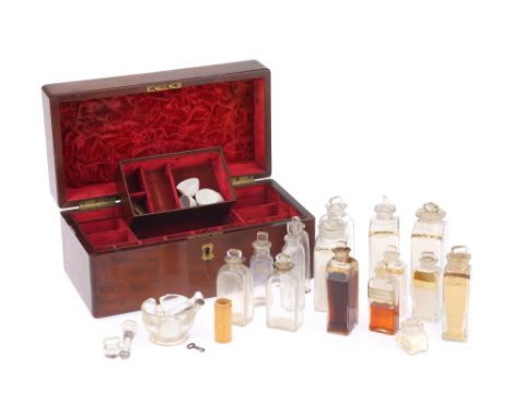 A Victorian Apothecary Case English, c.1860, the case opening to reveal 14 bottles arranged around a center lift out tray con