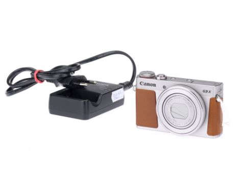 A Canon Powershot G9 X Compact Digital Camera chrome-brown-ochre, with a Canon 3x IS f/2.0-4.9 10.2-30.6mm zoom lens, battery