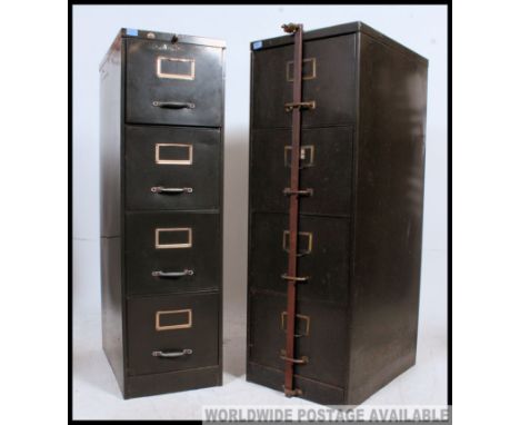 A near pair of mid century air ministry military green upright filing cabinets. Each with notation slides, one with cast iron