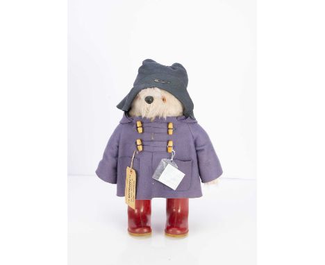 A Gabrielle Design Paddington Bear, with blue duffle coat, dark blue hat, red Dunlop wellies, cloth label in back seam, lugga