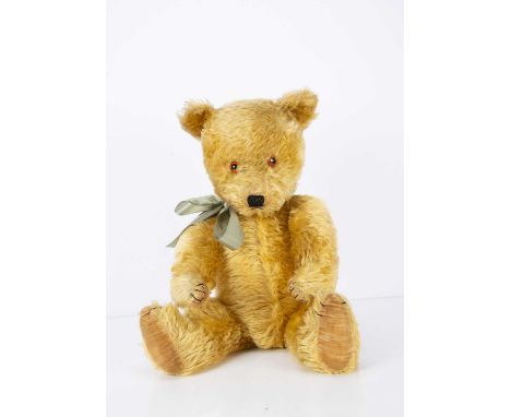 A post-war Chiltern Hugmee Teddy Bear, with golden mohair, orange and black glass eyes, pronounced muzzle, black stitched nos